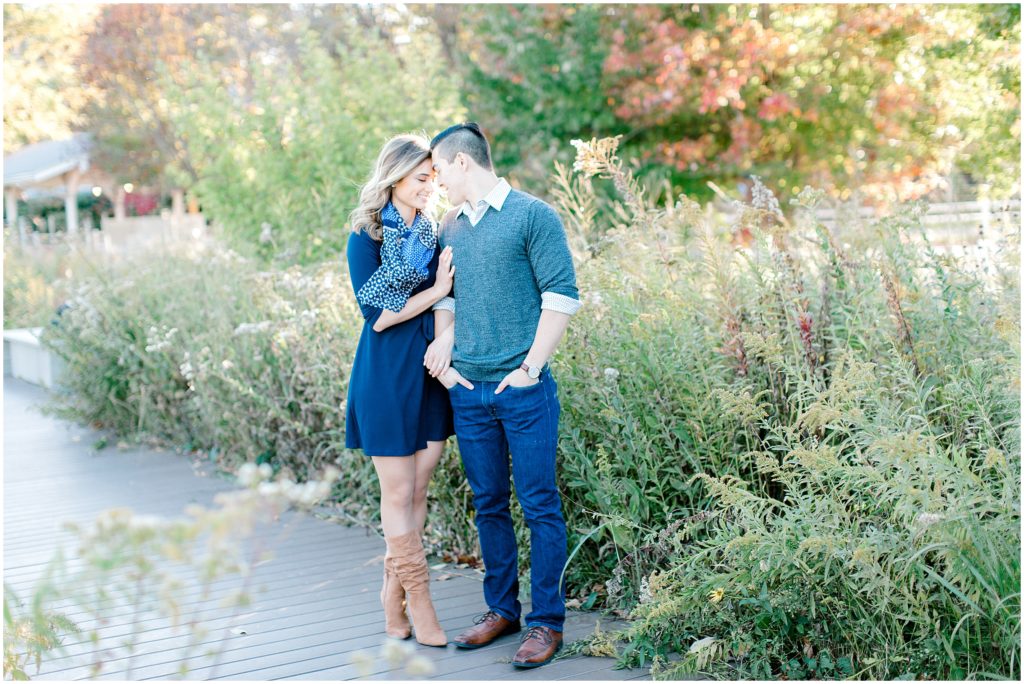 couple standing on the background of tall grass in Chicago Lincoln park during an engagement session by Bozena Voytko Photography
