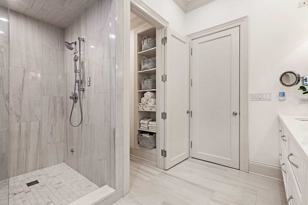 shower and bathroom picture with towel closet by Chicago real estate photographer
