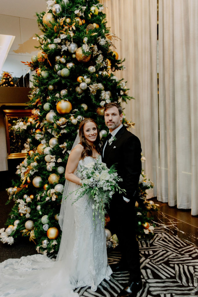 bride and groom by the Christmas tree