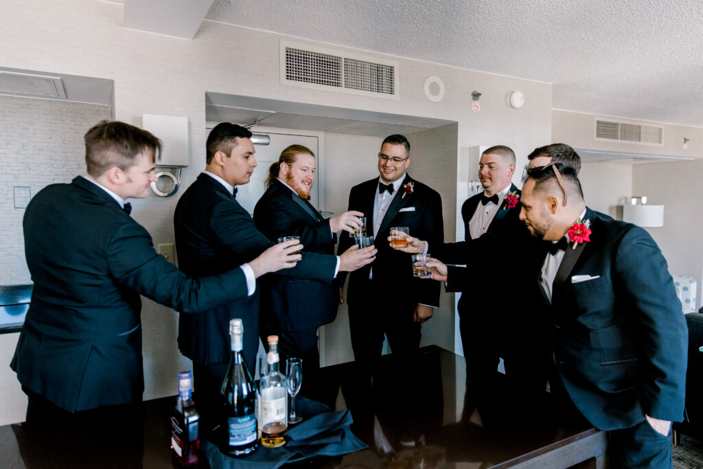 groom and groomsman toasting in the getting ready room