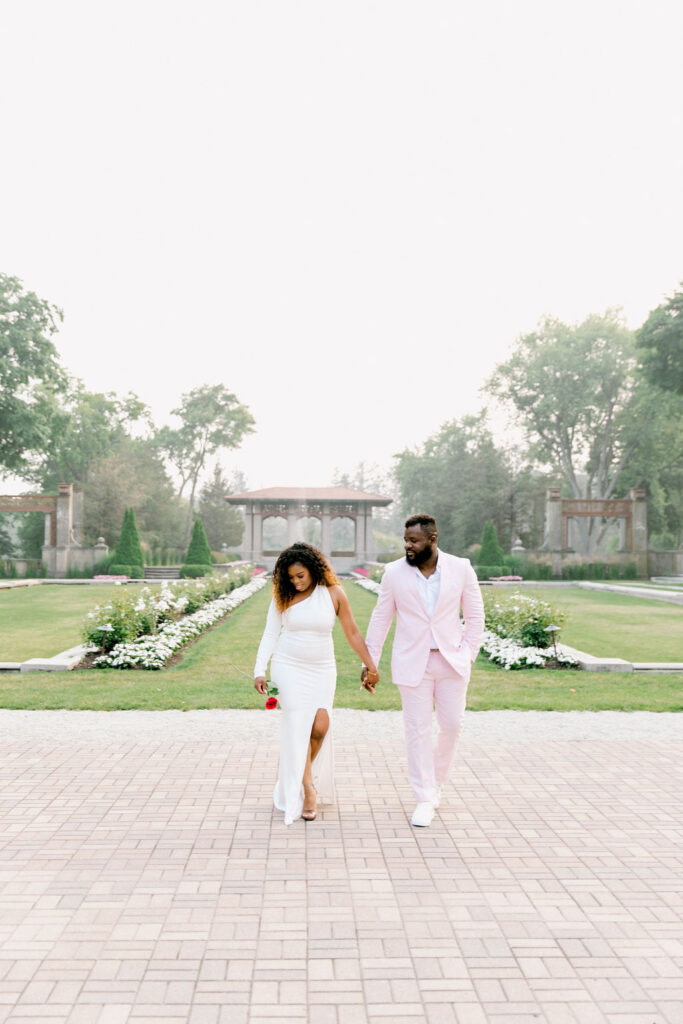 The groom's pink suit effortlessly blends with the romantic surroundings of Armour House, reflecting their vibrant personalities.