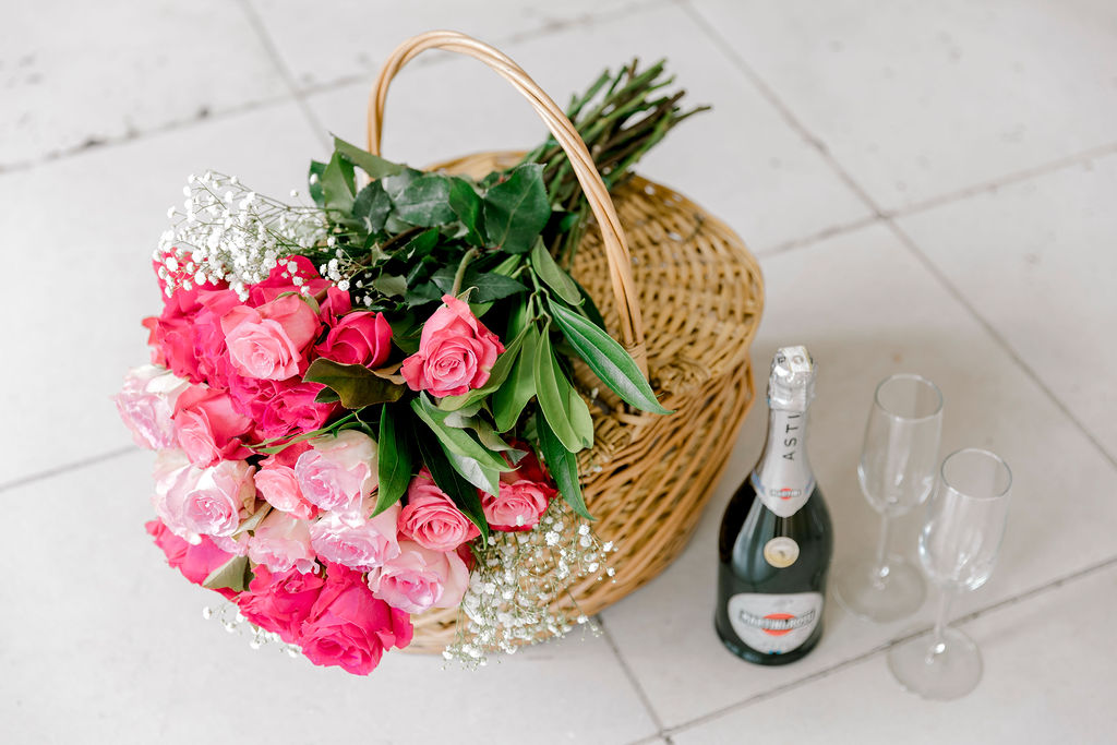 Picnic basket with champagne at Armour House: A thoughtfully arranged picnic basket filled with delectable treats and a bottle of champagne, creating a romantic setting within the enchanting grounds of Armour House.