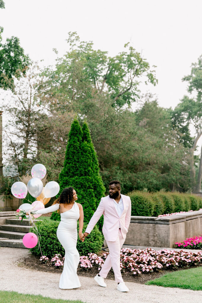 Balloon-filled backdrop: A whimsical setting adorned with an array of balloons, forming a captivating backdrop for the engagement session, creating a sense of enchantment and playfulness.