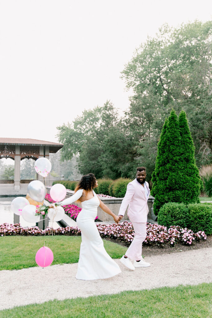 The groom's dashing pink suit adds a touch of uniqueness and flair to their Armour House engagement session.