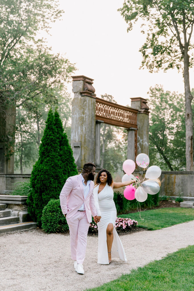 The groom's pink suit stands out in the lush greenery of Armour House, symbolizing his devotion and commitment to their love story.