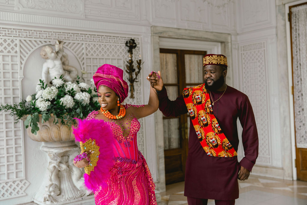 Embracing their Nigerian heritage, the couple dons custom-made fuchsia outfits, blending cultural richness with modern romance.
