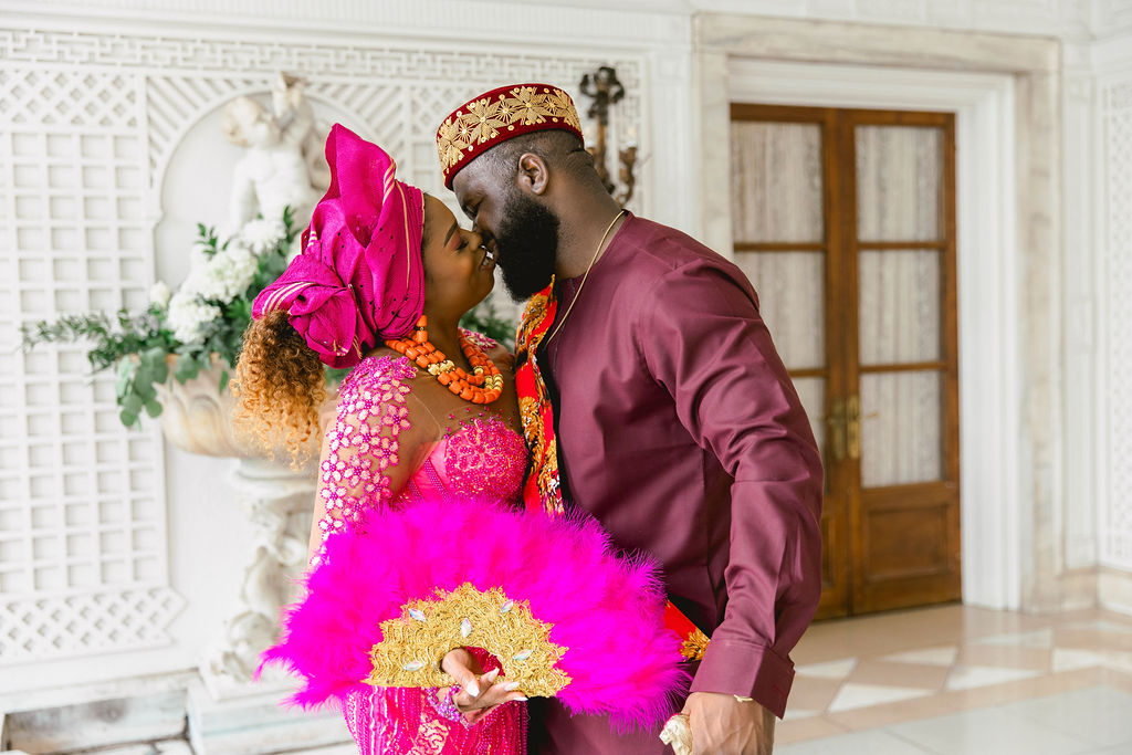 In their bespoke fuchsia ensembles, the couple radiates pride and elegance, paying homage to their Nigerian roots during their summer engagement session.