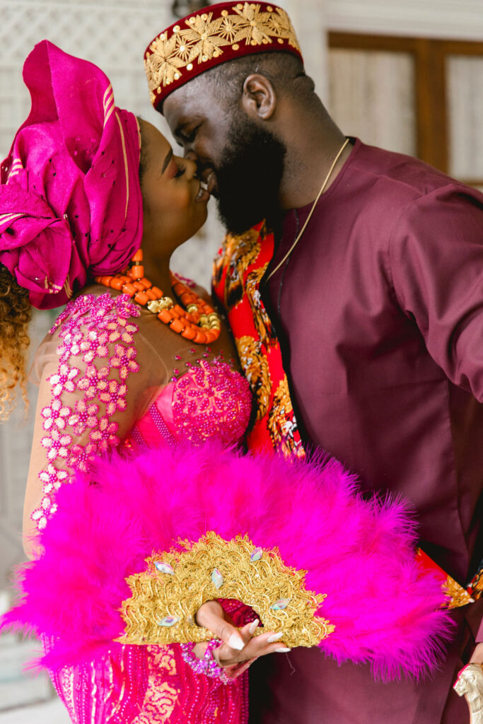 The groom's meticulously tailored fuchsia suit and the bride's stunning custom-made fuchsia gown beautifully represent the blending of their love and Nigerian traditions at Armour House.