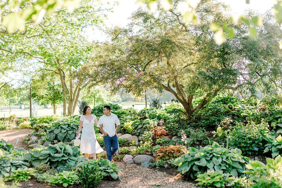 Couple laughing together while walking under blooming trees at Cantigny Park.