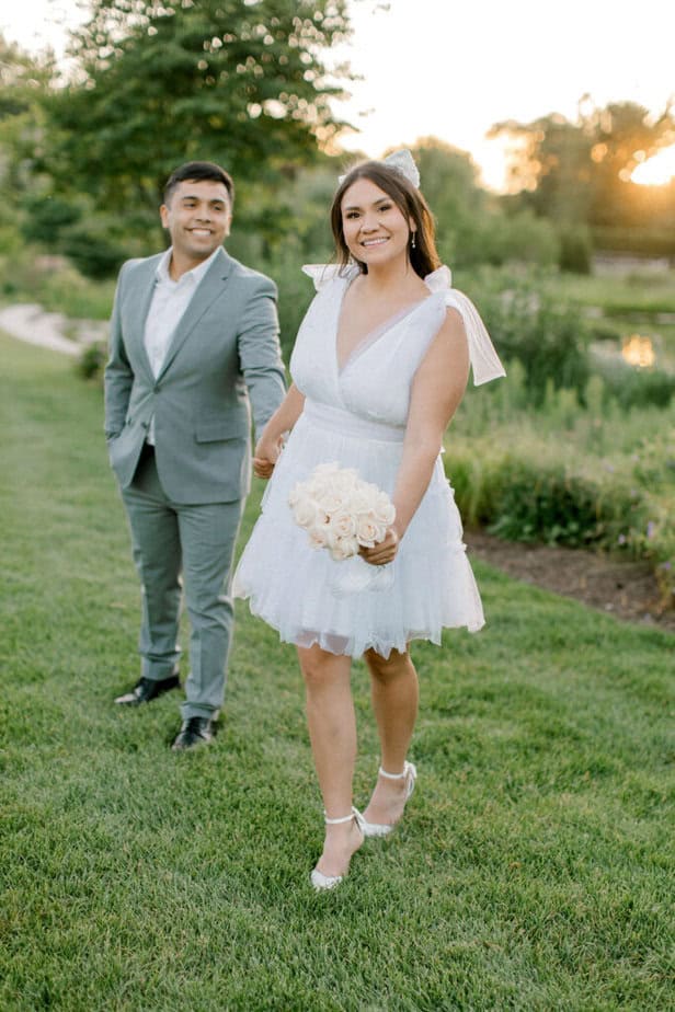 Engaged couple sharing a quiet, intimate moment surrounded by vibrant floral gardens.